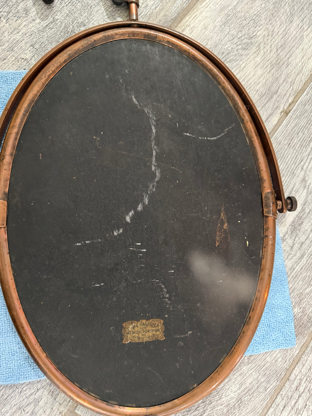 Back of oval mirror showing condition and label