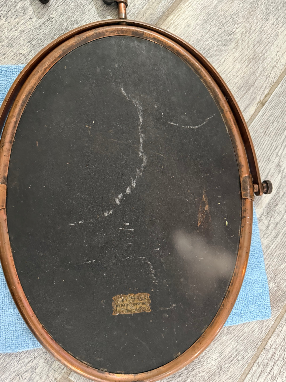 Back of oval mirror showing condition and label