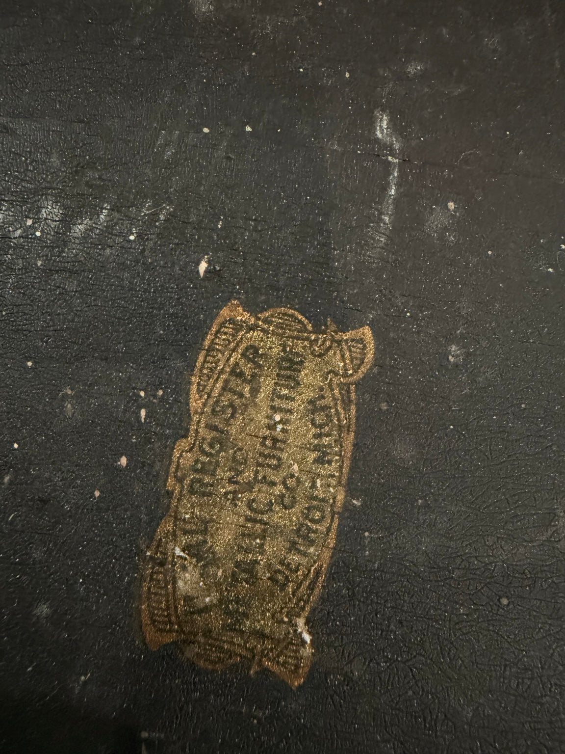 Close view of worn label on back of mirror