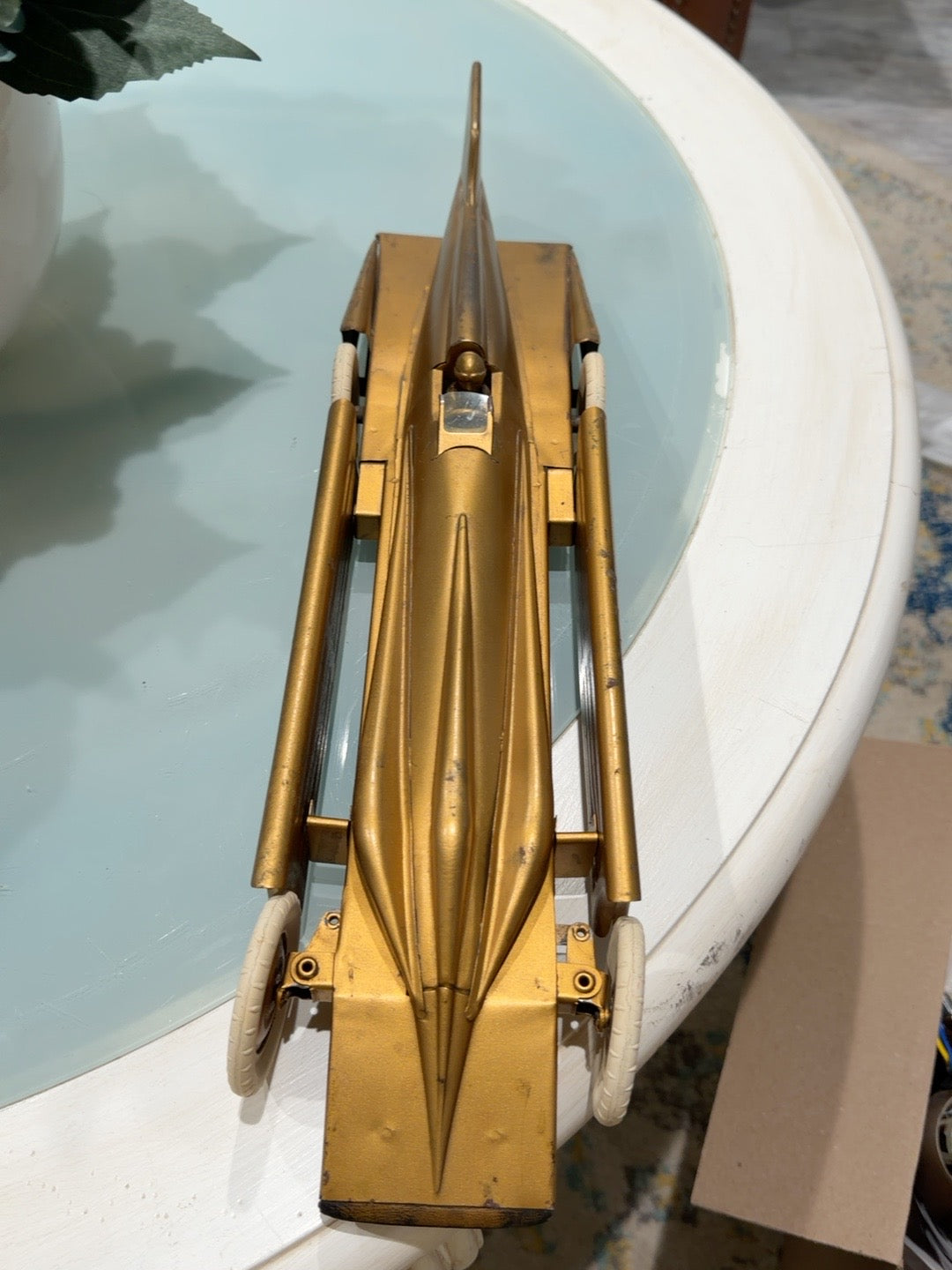 Overhead view of streamlined gold Golden Arrow racer