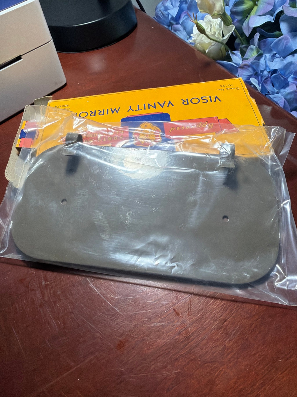 Back of Oldsmobile visor vanity mirror part 982178 showing mounting hardware
