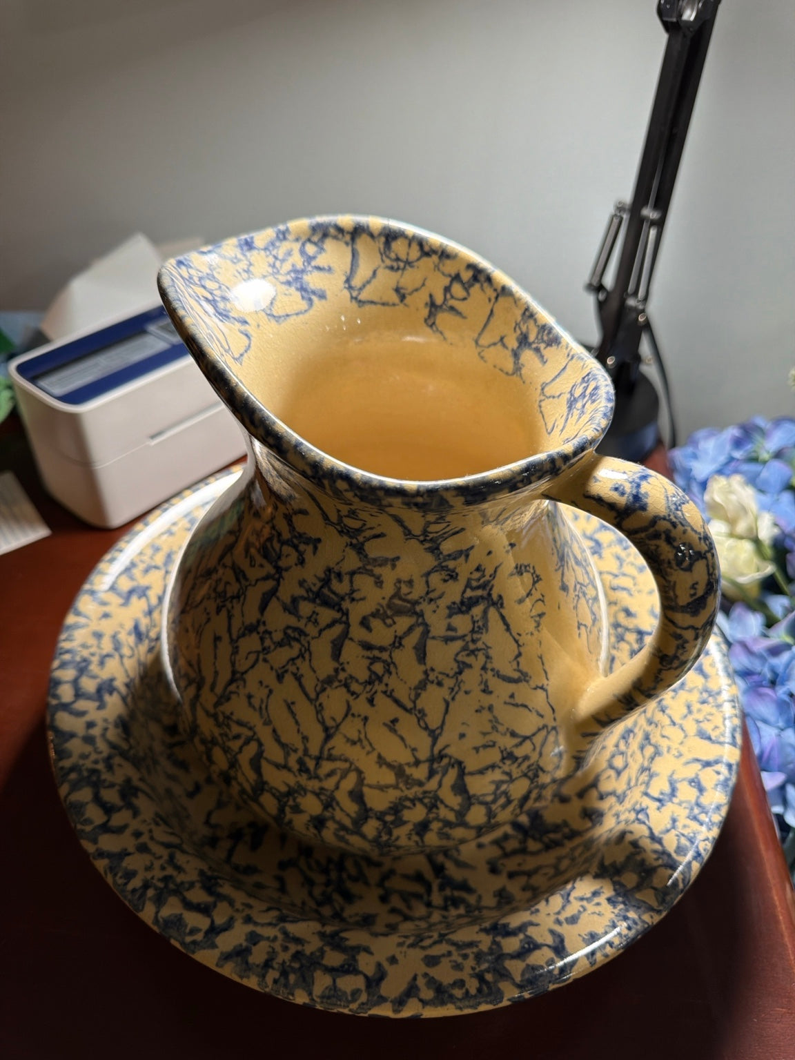 Cream and blue spongeware pitcher nested in matching wash basin